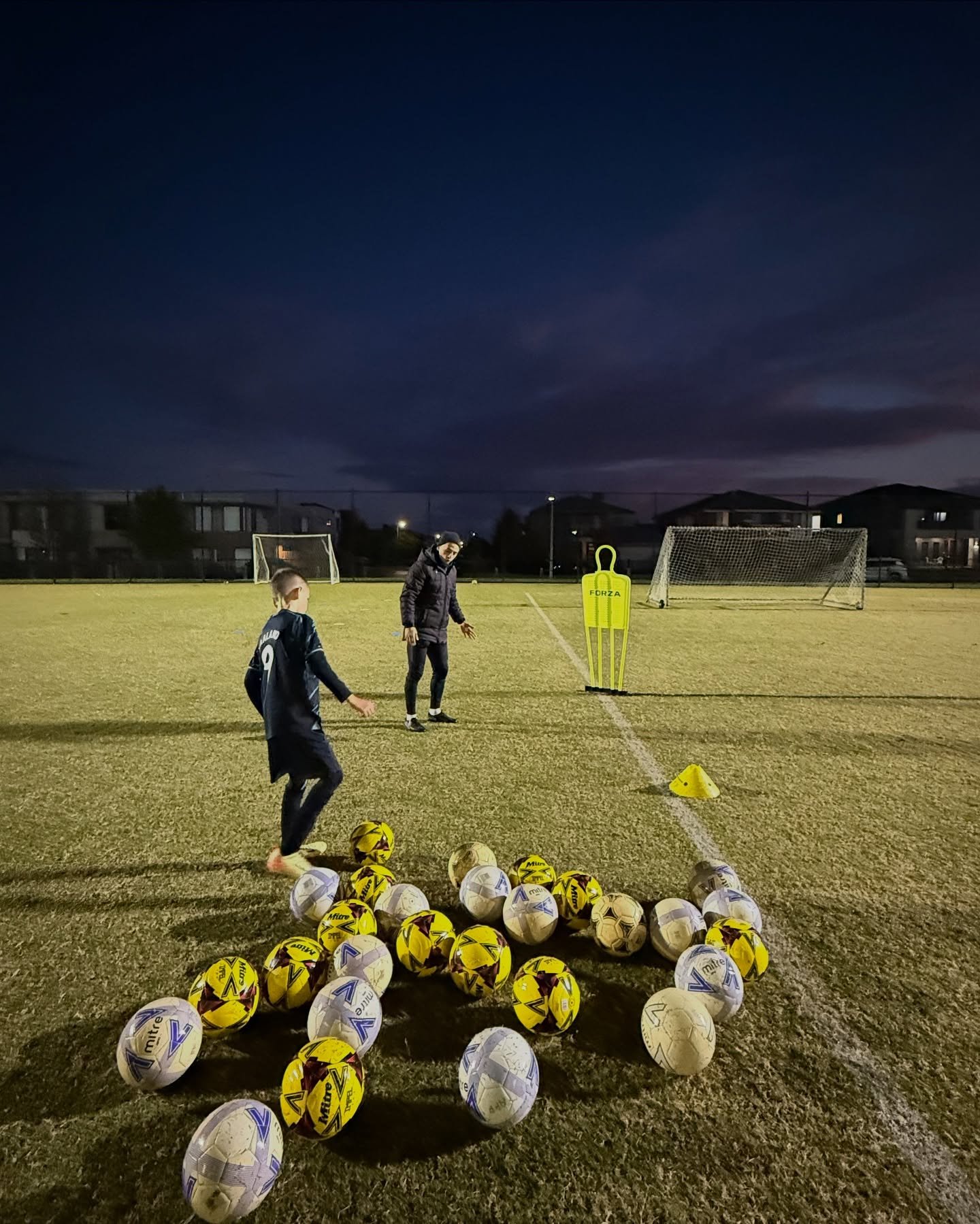 Coach Chris working with a junior player on technique